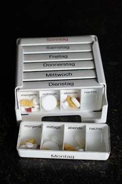 German pill organizer box for sorting daily and weekly medication doses Stock Photos