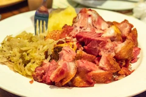 German pork fried with vegetables on a white plate Stock Photos