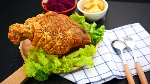 German pork knuckle with mashed potato and sauerkraut rotate on black food table Stock-Footage 131692619