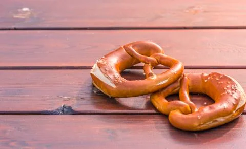 German pretzel in sunlight on table Stock Photos