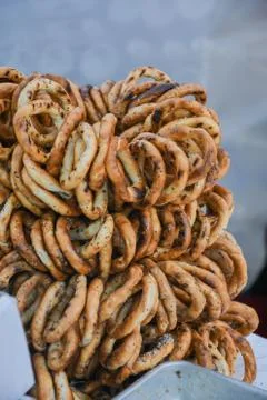 German pretzels stack one over each other, group of thin dry pretzels on rope Stock Photos