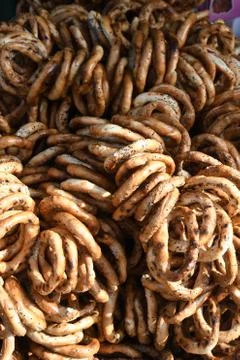 German pretzels stack one over each other, group of thin dry pretzels on rope Foto stock