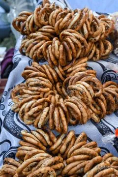 German pretzels stack one over each other, group of thin dry pretzels on rope Stock Photos