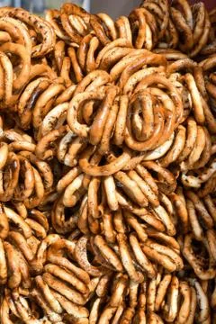 German pretzels stack one over each other, group of thin dry pretzels on rope Foto stock