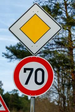 German priority road and 70 km/h speed limit signs Stock Photos
