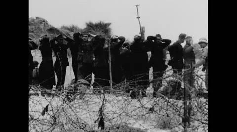 German prisoners of war taking cover on beach Stock Footage 44575066