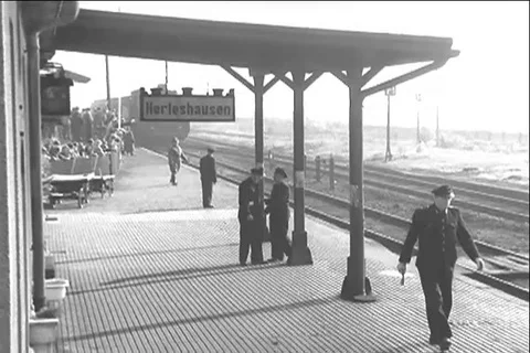 German prisoners wave from the train as it reaches Herleshausen station - 1955 Stock Footage 117666779