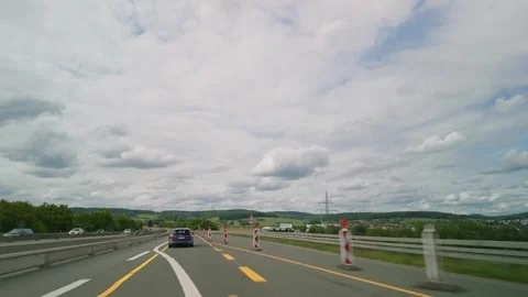 German road construction with slow moving vehicles, temporary markings, cones Stock Footage 337422574