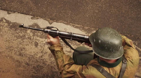 German soldier of war world two shoots from mashinegun in slow motion Stock Footage