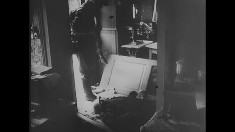 German soldiers advance through empty town, cross canal 動画素材 103378490