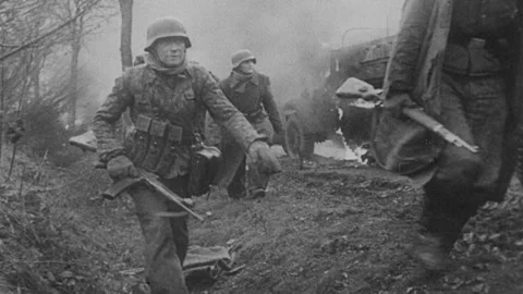 German Soldiers Pass Burning American Co... | Stock Video | Pond5