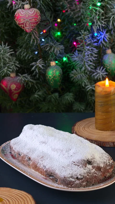 German Stollen cake on a Christmas table with candles.  Vertical video. Stock Footage 281592801