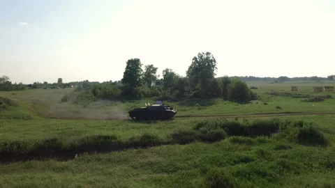 German tank rides through a field in the forest, top view shot from a drone Stock Footage 101068018