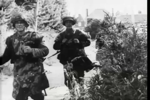 German tanks, troops move behind the tanks and parachute caught in tree - 1944 Stock Footage 93846517