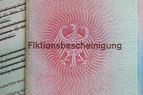 German temporary Permanent resident card lies on wooden table Stock Photos