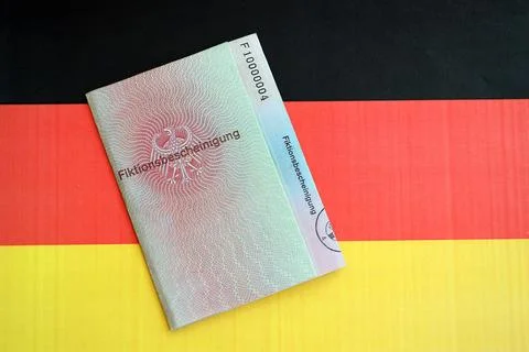 German temporary Permanent resident card lies on Germany flag Stock Photos