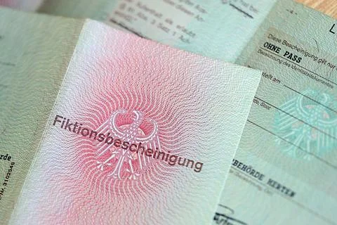 German temporary Permanent resident card lies on wooden table Stock Photos