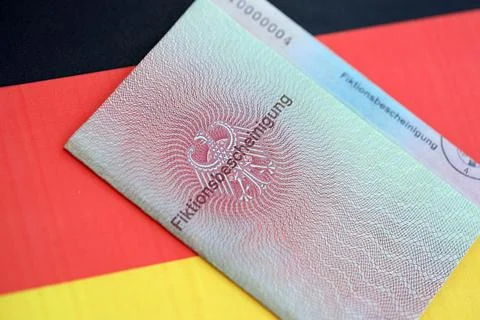 German temporary Permanent resident card lies on Germany flag Stock Photos