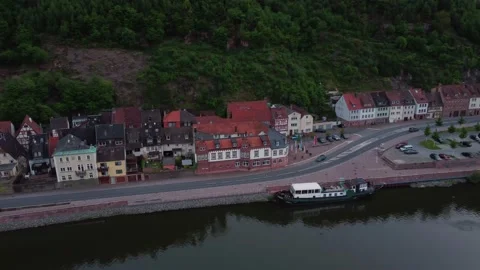 A german town in front of a red mountain next to a river 動画素材 154486863