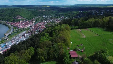 A german town next to a forest and a meadow from above Stock Footage 154416490