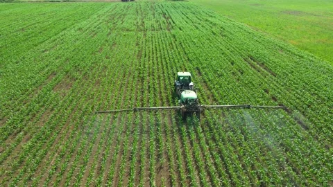 German tractor spraying on field with sprayer, herbicides and pesticides Stock Footage 232061839