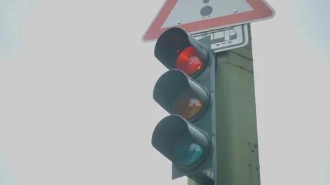 German Traffic light at road crossing turns from Red to Yellow to Green . Stock Footage 128980458