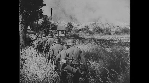 German troops advance through burning buildings in French town Stock Footage 103378449