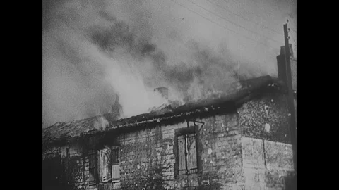 German troops advance through burning buildings in French town Stock Footage 103378454