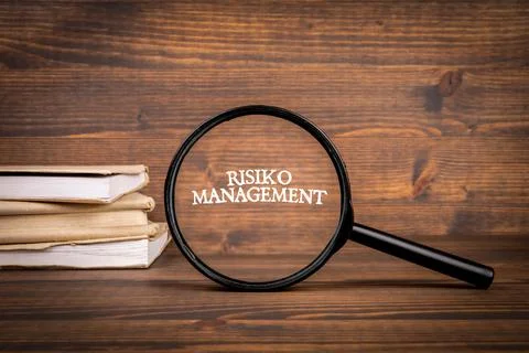 German word Risiko Management, risk management. Magnifying glass with text Stock Photos