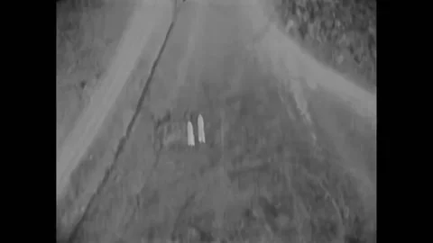 GERMANY - 1927 - In this silent comedy, two men stand in a bombing field and Stock-Footage 325202001