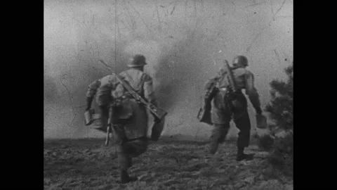 Germany 1940s: Bombs explode. Soldiers run through smoke in battlefield. Stock Footage 236922980