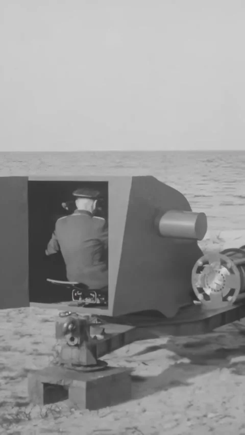 GERMANY - 1940s - A Nazi officer test fires a guided missile from the beach. 動画素材 340321453
