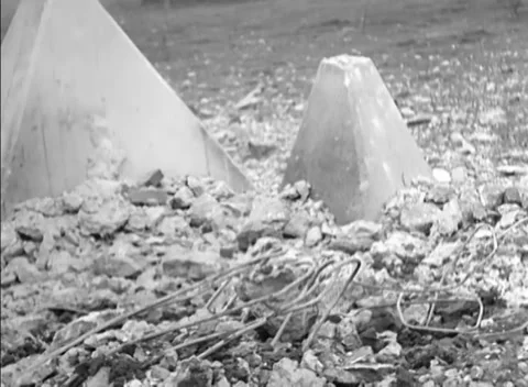 GERMANY - 1944: Barrier damage - Twisted Rebar Surrounds Concrete Pyramids Stock Footage 344493781