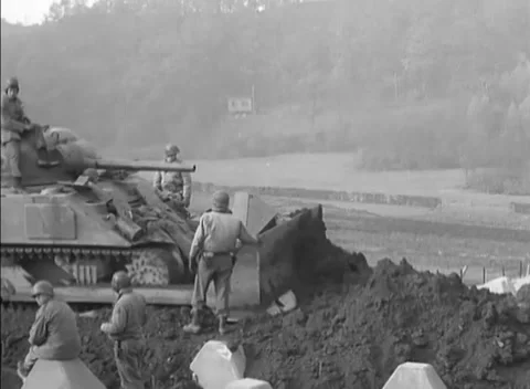 GERMANY - 1944: Siegfried Line dozer work - Soldiers inspect tank dozer Stock Footage 344493802