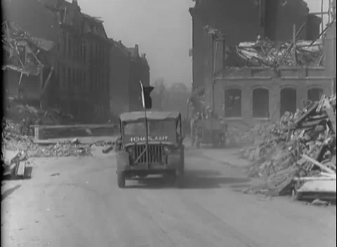 GERMANY - 1945: Arcaded shell - Cargo trucks enter shattered streets Stock-Footage 344488478