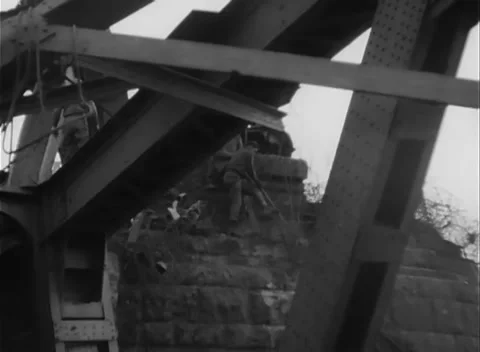 GERMANY - 1945: Bridge Collapse - Boat Rides Below Tangled Trusses Stock Footage 343942504