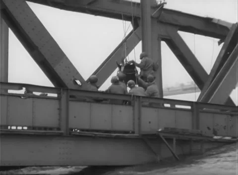 GERMANY - 1945: Bridge Collapse - Crew Hauls Lines Over the Rail Stock Footage 343942531