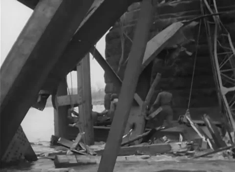 GERMANY - 1945: Bridge Collapse - Work Continues Inside the Steel Tangle Stock Footage 343942554