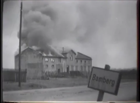GERMANY - 1945: Collapsing roofline fire - Bamberg sign by a burning building Stock Footage 344600469
