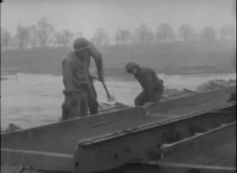 GERMANY - 1945: Combat engineers - Beam carrier passes working bridge crane Stock Footage 344493532