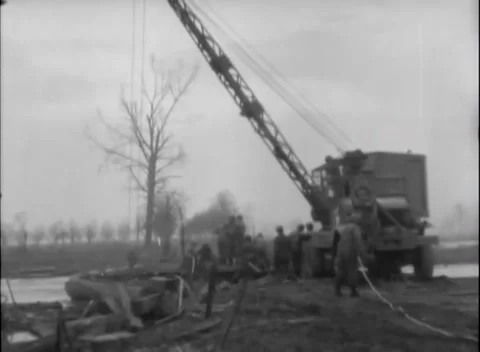 GERMANY - 1945: Combat engineers - Crane truck handles bridge sections Stock Footage 344493584