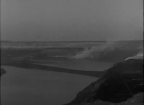 GERMANY - 1945: Crossing battlefield - Thin smoke drifts across open river plain Stock Footage 344493499