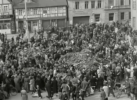 GERMANY - 1945: Elevated street view - Dense crowd fills town square Stock Footage 344487073