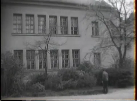 GERMANY - 1945: Facility exterior - Institutional buildings beyond bare trees Stock Footage 344486907