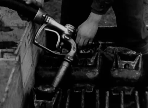 GERMANY - 1945: Field filling process - Hand guides nozzle over open containers Stock Footage 344486925