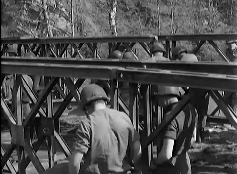 GERMANY - 1945: Girder handling - Work Party Guides a Long Steel Member Stock Footage 344494040
