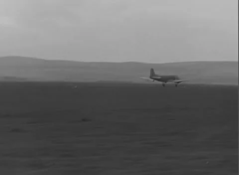 GERMANY - 1945: Hillside landing path - Transport flies low over Fritzlar field 스톡 동영상 344487537