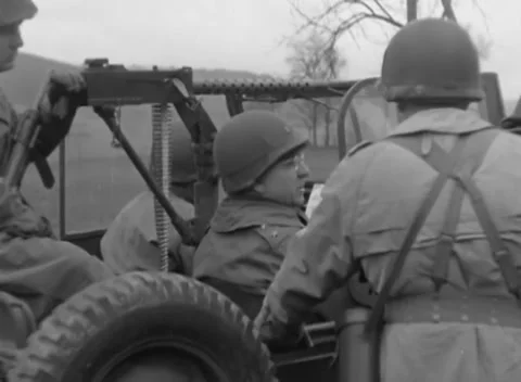 GERMANY - 1945: Map briefing - Officers confer around a machine-gun jeep Stock Footage 344488193
