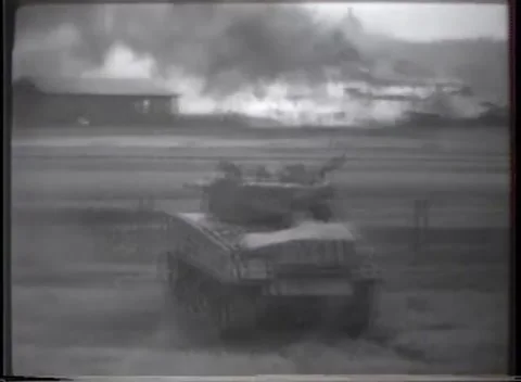 GERMANY - 1945: Open compartment crew - Tank destroyer passes burning warehouses Stock-Footage 344600460