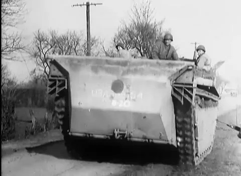GERMANY - 1945: Prisoner movement - Prisoner Column Passes Brick Barracks Stock Footage 344493980